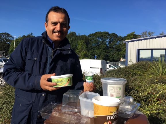 Leader of Pendle Council, Councillor Iqbal with plastic you can now add to your brown recycling bin.