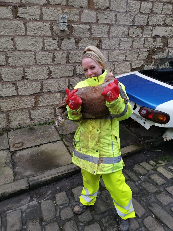 Photo of volunteer Carley who helped with sandbags